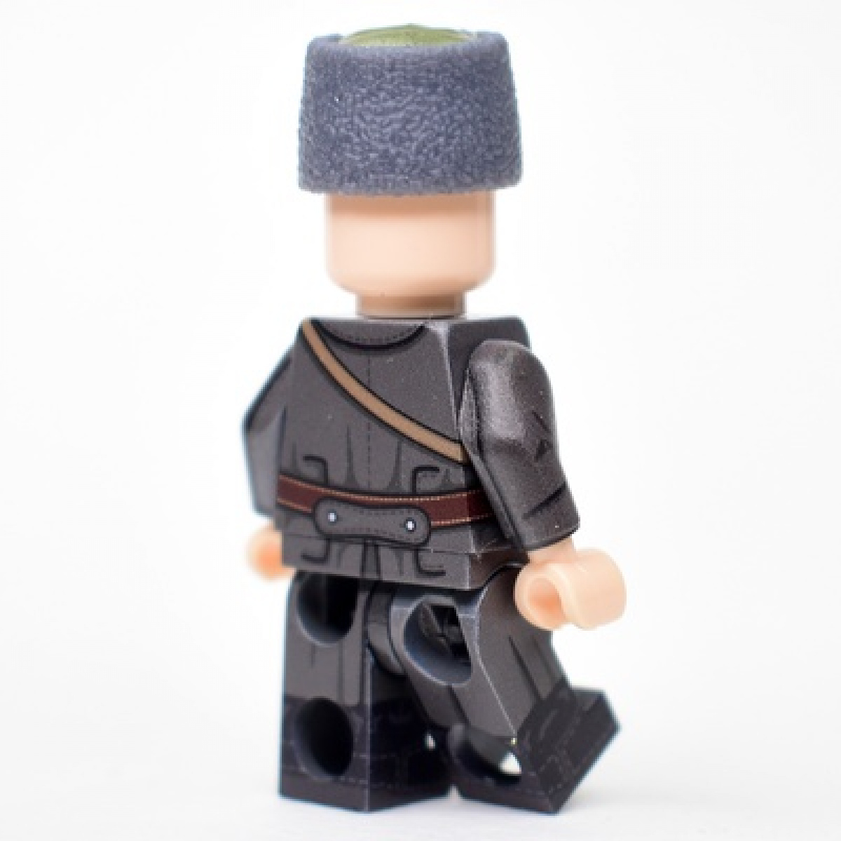 Red Army soldier in an overcoat and papakha with ribbon for the period of the Civil War